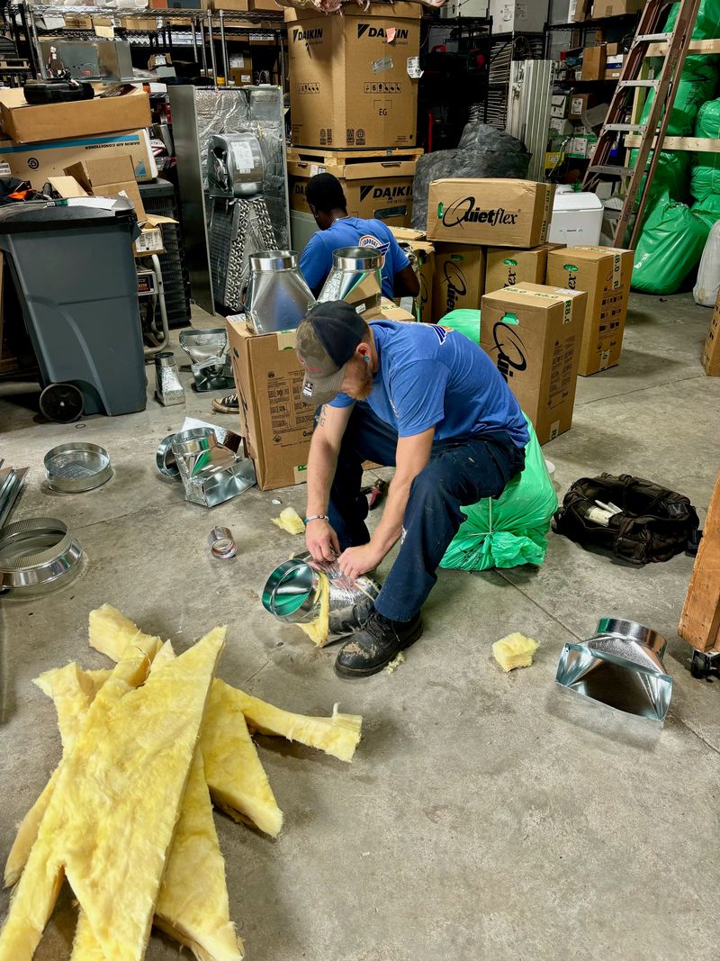 Air Support technician fabricating custom sheet metal ductwork with Daikin and Quietflex supplies
