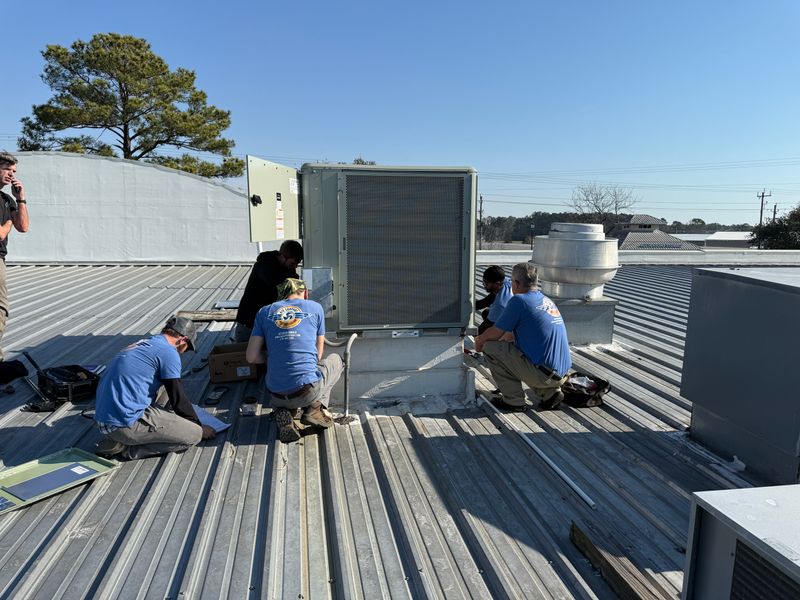Air Support team of five technicians installing a commercial rooftop HVAC unit