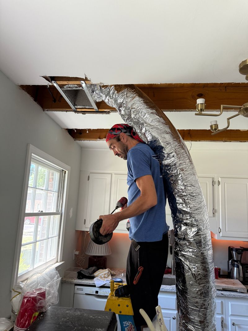 Air Support technician installing insulated flex duct runs in a residential home