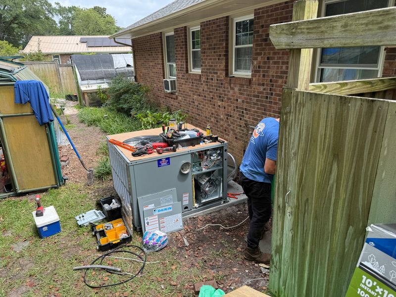 Air Support technician connecting refrigerant lines on a new Daikin heat pump installation