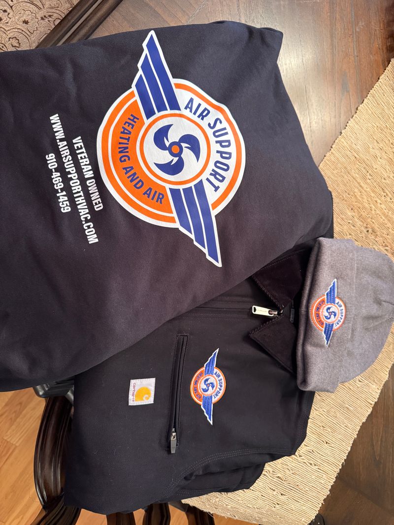 Air Support Heating and Air branded Carhartt jacket, t-shirt, and beanie with veteran-owned logo