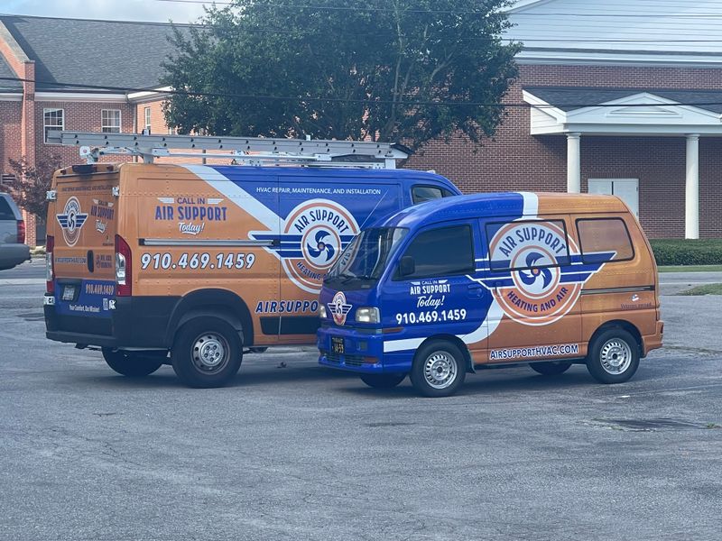 Air Support branded service van and mini delivery truck parked together