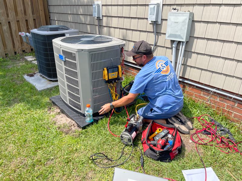 Air Support technicians diagnosing an American Standard outdoor condenser unit at a residential home