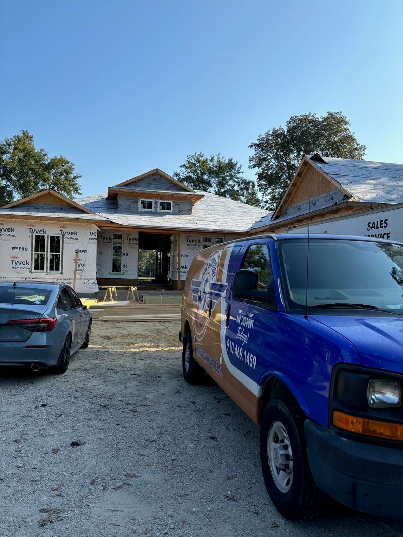 Air Support branded van parked at a new construction home site