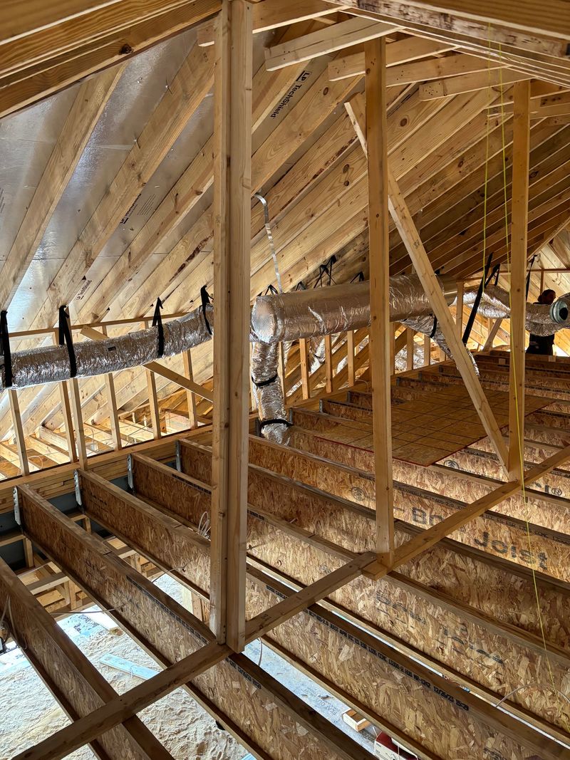 Insulated flex duct runs installed in new construction attic framing and trusses