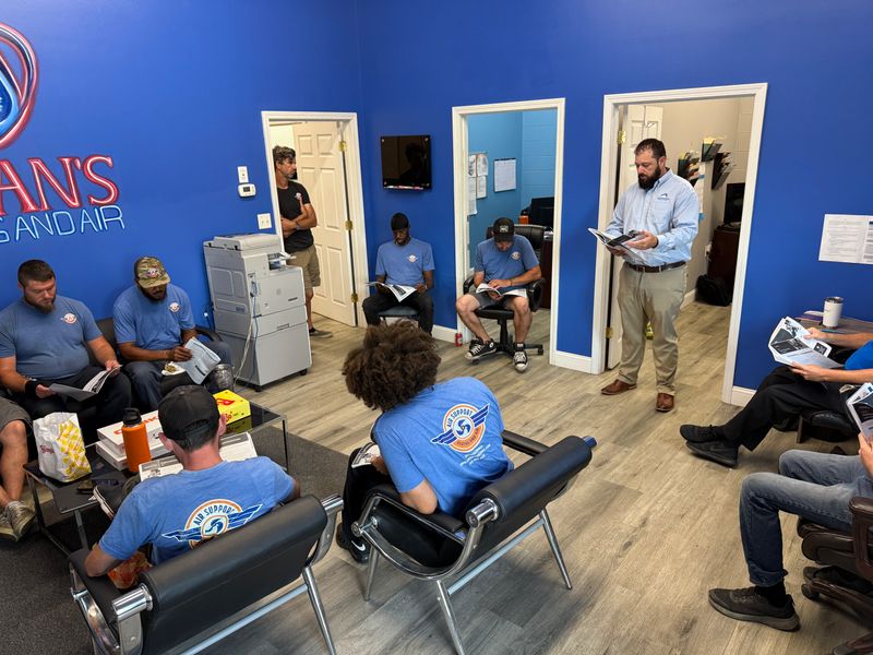Air Support team in a training session at the blue-walled company conference room