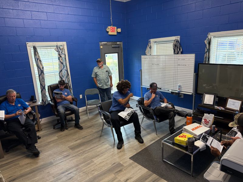 Air Support technicians reviewing training materials during a team meeting