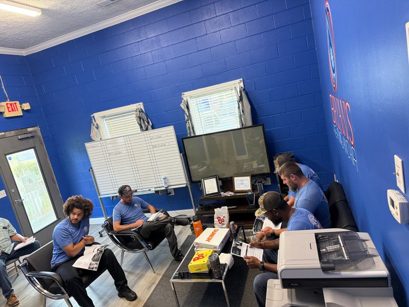 Air Support team members at a meeting in the company break room with snacks