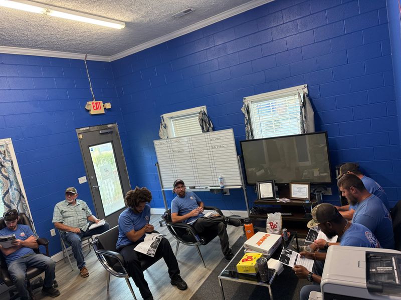 Air Support team members reviewing materials at a morning meeting