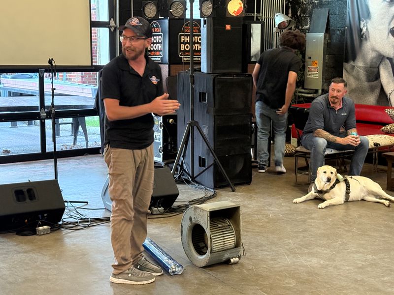 Air Support owner speaking at a community event venue with HVAC blower motor demonstration