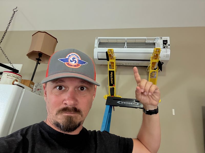 Air Support technician selfie leveling a newly installed ductless mini-split indoor unit